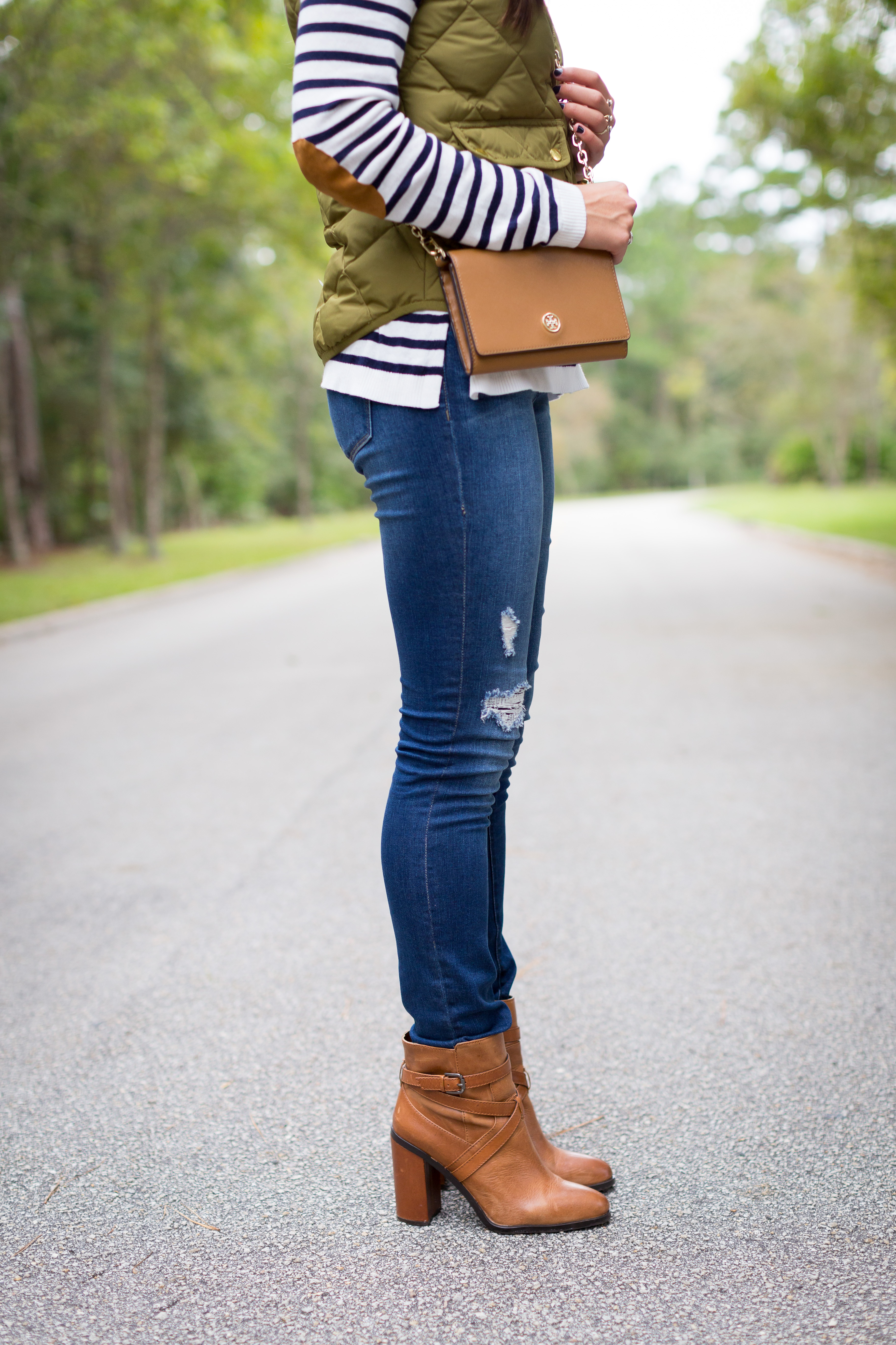 stripe tee, elbow patches, elbow patch sweater, stripe sweater, distressed skinny jeans, excursion vest, tory burch wallet on a chain, brown booties, fall fashion, preppy fall outfit // grace wainwright from a southern drawl