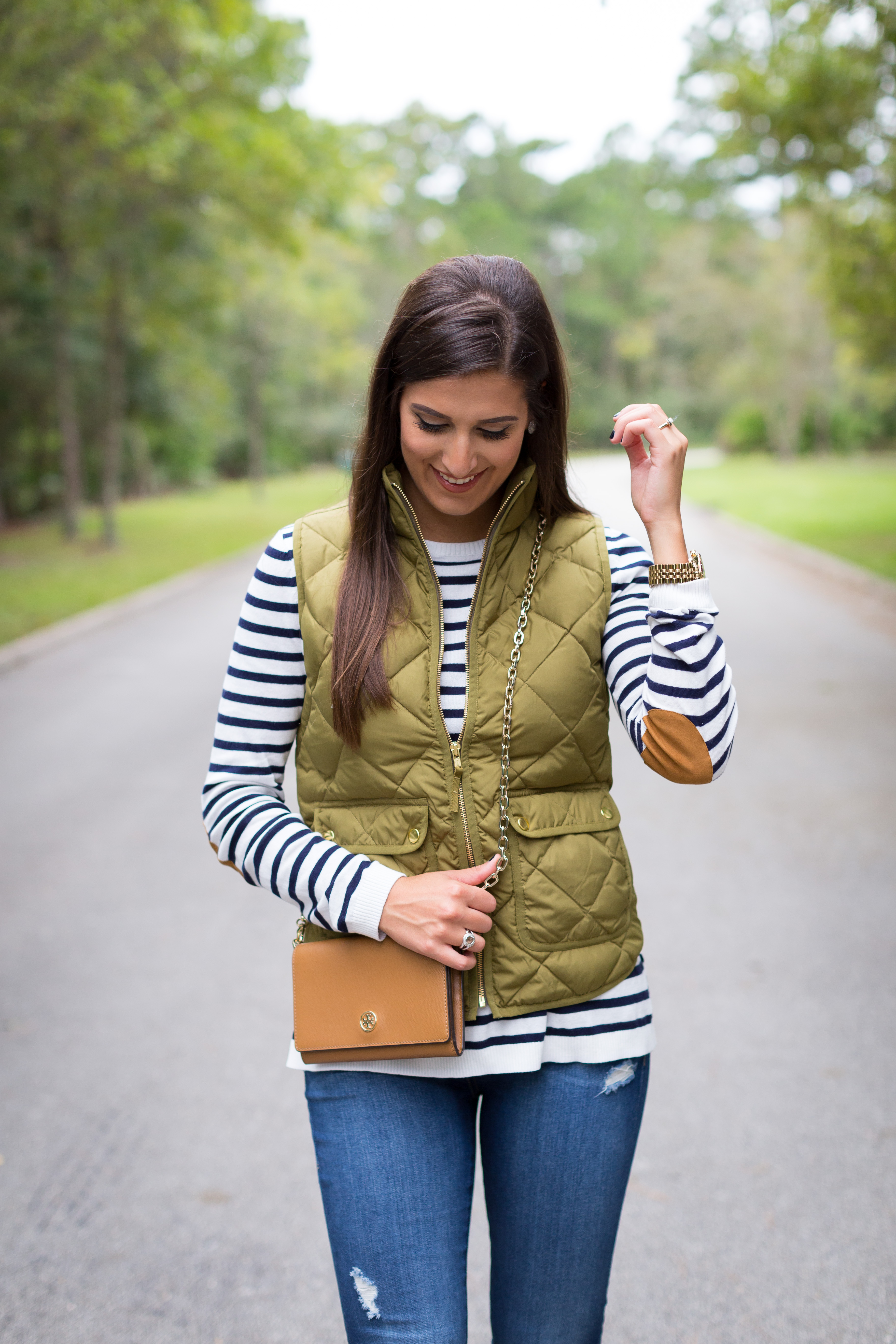stripe tee, elbow patches, elbow patch sweater, stripe sweater, distressed skinny jeans, excursion vest, tory burch wallet on a chain, brown booties, fall fashion, preppy fall outfit // grace wainwright from a southern drawl