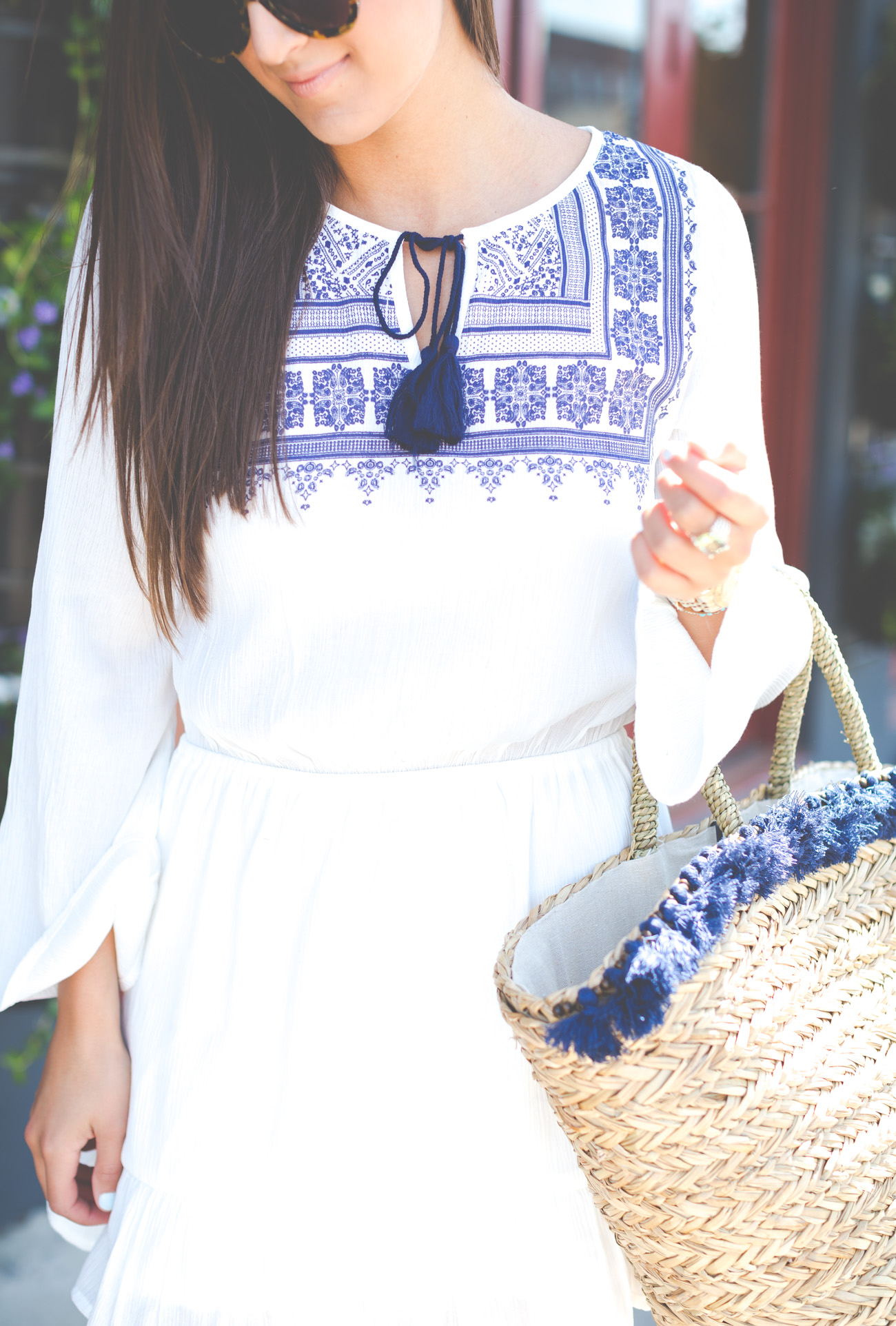 embroidered white dress, tassel white dress, white and navy dress, white summer dress, little white dress, ruffle white dress, white ruffle dress, tassel tote, tassel outfit, straw tote, straw tassel tote, hat attack tassel straw tote, charleston south carolina, preppy outfit, preppy fashion, spring fashion, spring style, embroidered outfit, wilde heart fine china dress // grace wainwright from a southern drawl