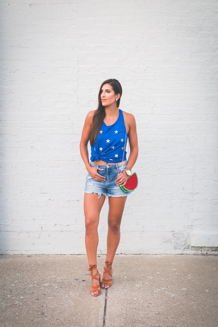 star print racerback tank, fourth of july outfit inspo, fourth of july outfit, fourth of july fashion, merican tank, star tank, watermelon purse, watermelon bag, watermelon crossbody bag, denim cutoffs,  high waist denim shorts, high waist denim cutoffs, july fourth outfit ideas, fun july fourth outfits, fruit purse, summer outfit ideas, knotted tee, how to knot your tank, knotted tank, lace up sandals, lace up heels, sole society lyla sandals // grace wainwright a southern drawl