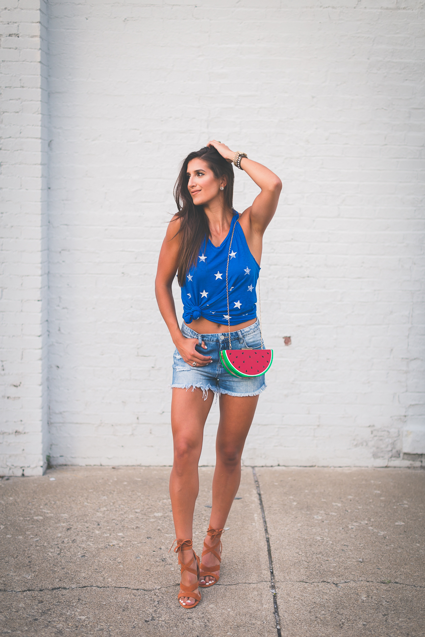 star print racerback tank, fourth of july outfit, fourth of july fashion, merican tank, star tank, watermelon purse, watermelon bag, watermelon crossbody bag, denim cutoffs,  high waist denim shorts, high waist denim cutoffs, july fourth outfit ideas, fun july fourth outfits, fruit purse, summer outfit ideas, knotted tee, how to knot your tank, knotted tank, lace up sandals, lace up heels, sole society lyla sandals // grace wainwright a southern drawl