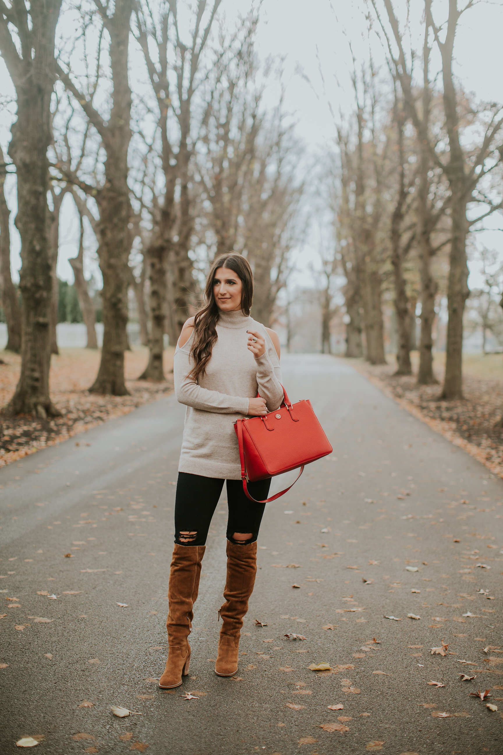 red tory burch tote, cold shoulder sweater, neutral cold shoulder sweater, cold shoulder tunic, distressed black jeans, over the knee boots, winter fashion, fall fashion, winter style // grace wainwright a southern drawl
