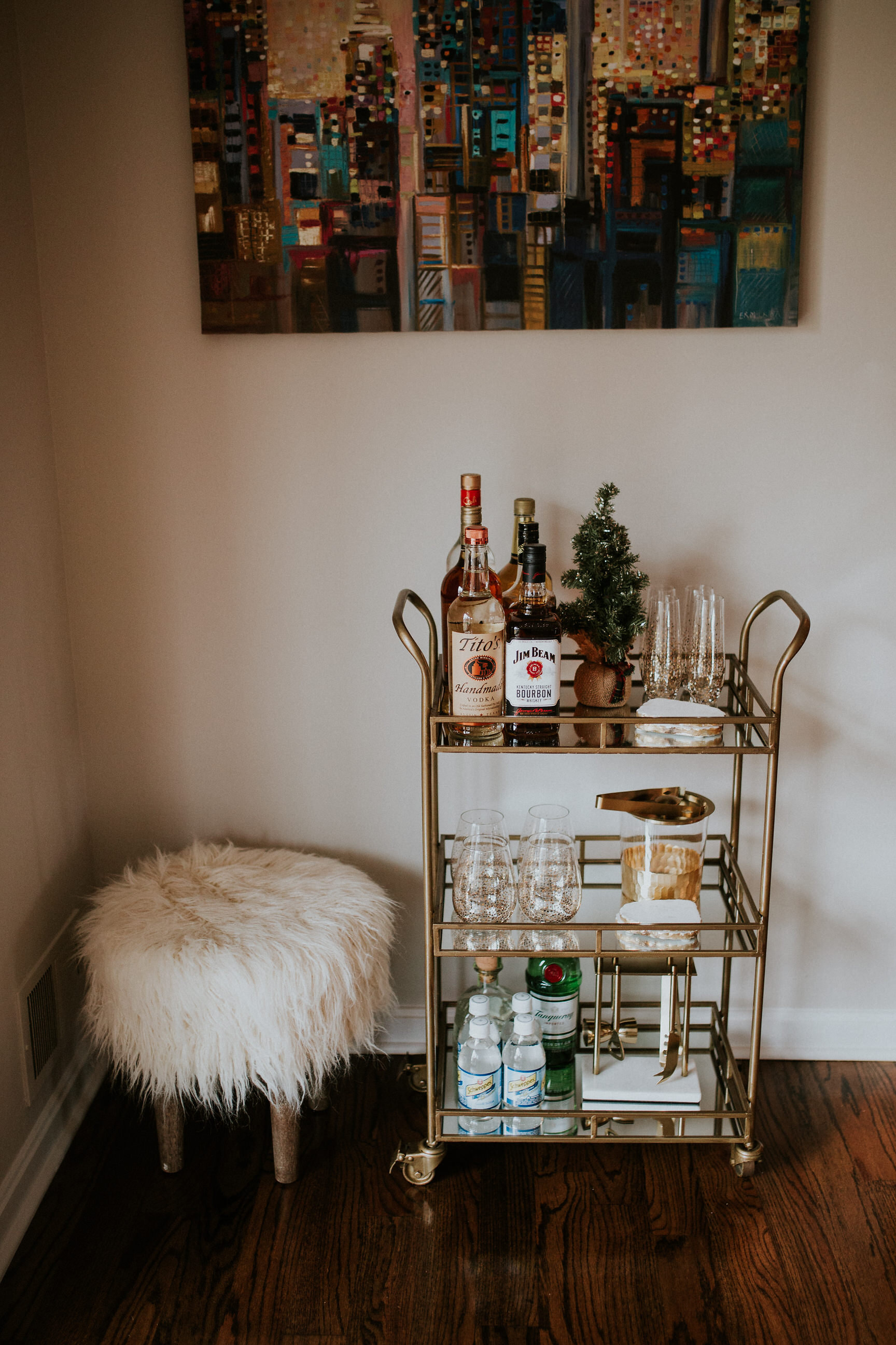 world market bar cart decor, gold bar cart, bar cart target, faux sheepskin stool, faux fur stool, what to put on a bar car, bar cart ideas, holiday hosting, how to host a holiday party, gold champagne glasses, gold rimmed wine glasses, agate coasters // grace wainwright a southern drawl