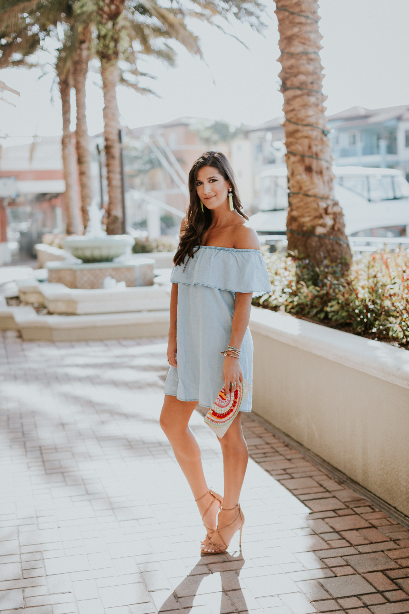 strappy neutral heels, embroidered clutch, tassel clutch, chambray off the shoulder dress, ruffle off the shoulder dress, chambray dress, embroidered clutch, vacation style, turquoise tassel earrings, nude wedges, strappy wedge sandals, tassel clutch // grace wainwright a southern drawl