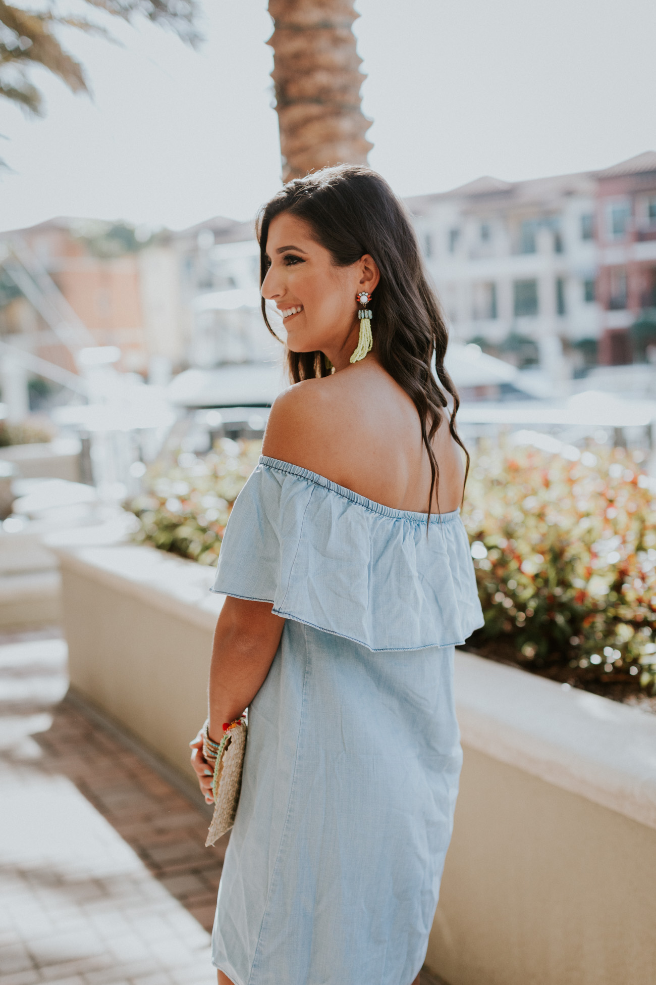 strappy neutral heels, embroidered clutch, tassel clutch, chambray off the shoulder dress, ruffle off the shoulder dress, chambray dress, embroidered clutch, vacation style, turquoise tassel earrings, nude wedges, strappy wedge sandals, tassel clutch // grace wainwright a southern drawl