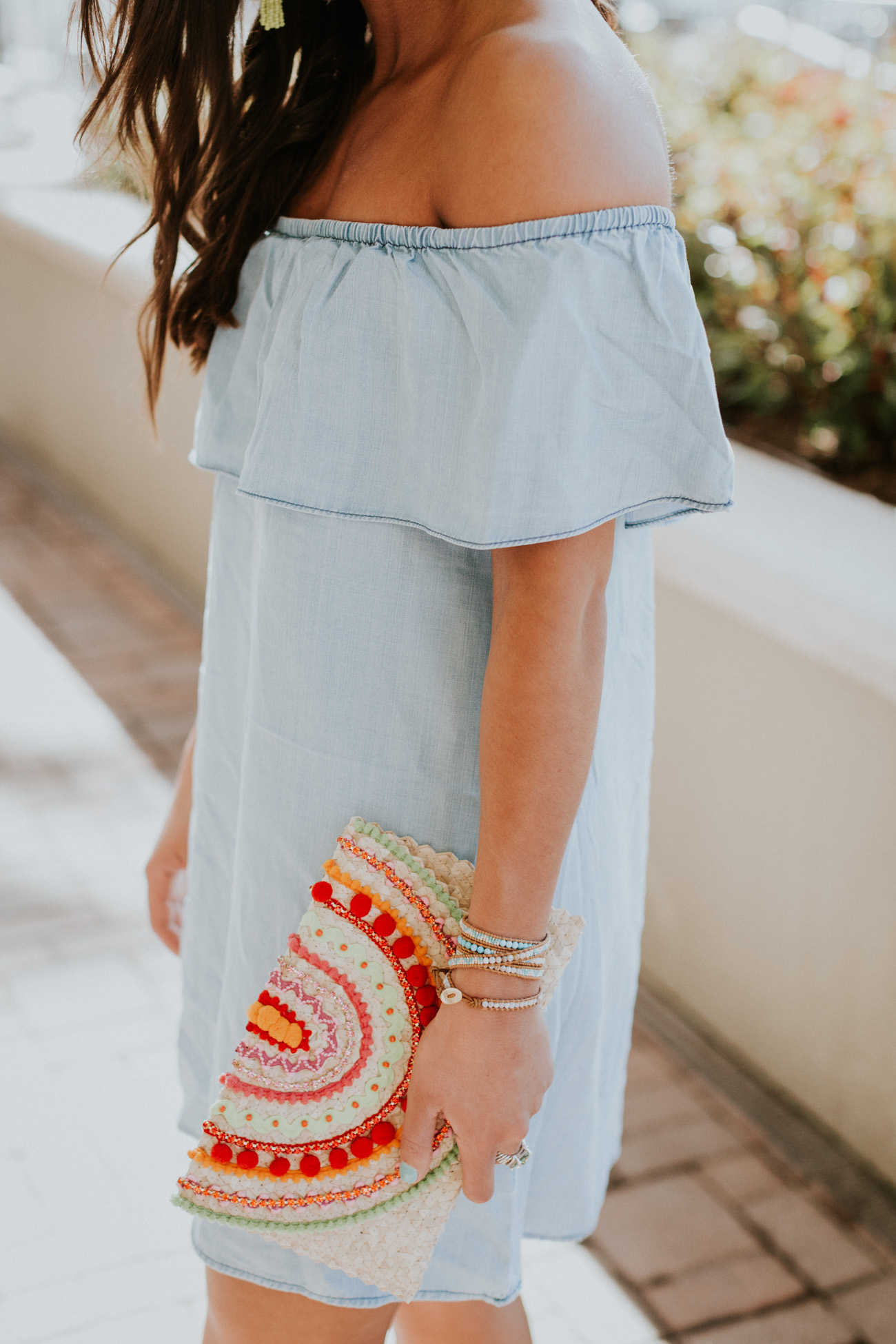 neon tassel earrings, strappy neutral heels, embroidered clutch, tassel clutch, chambray off the shoulder dress, ruffle off the shoulder dress, chambray dress, embroidered clutch, vacation style, turquoise tassel earrings, nude wedges, strappy wedge sandals, tassel clutch // grace wainwright a southern drawl