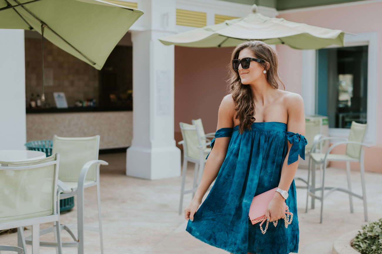 off the shoulder bow dress, blue life off the shoulder dress, blue life clothes, vacation outfit, vacation style, wraparound sandals, lace up sandals, celine sunglasses, pink tory burch bag, pink tory burch crossbody bag, tory burch chain wallet, bahamas outfit, beachside, beachy outfit // grace wainwright a southern drawl