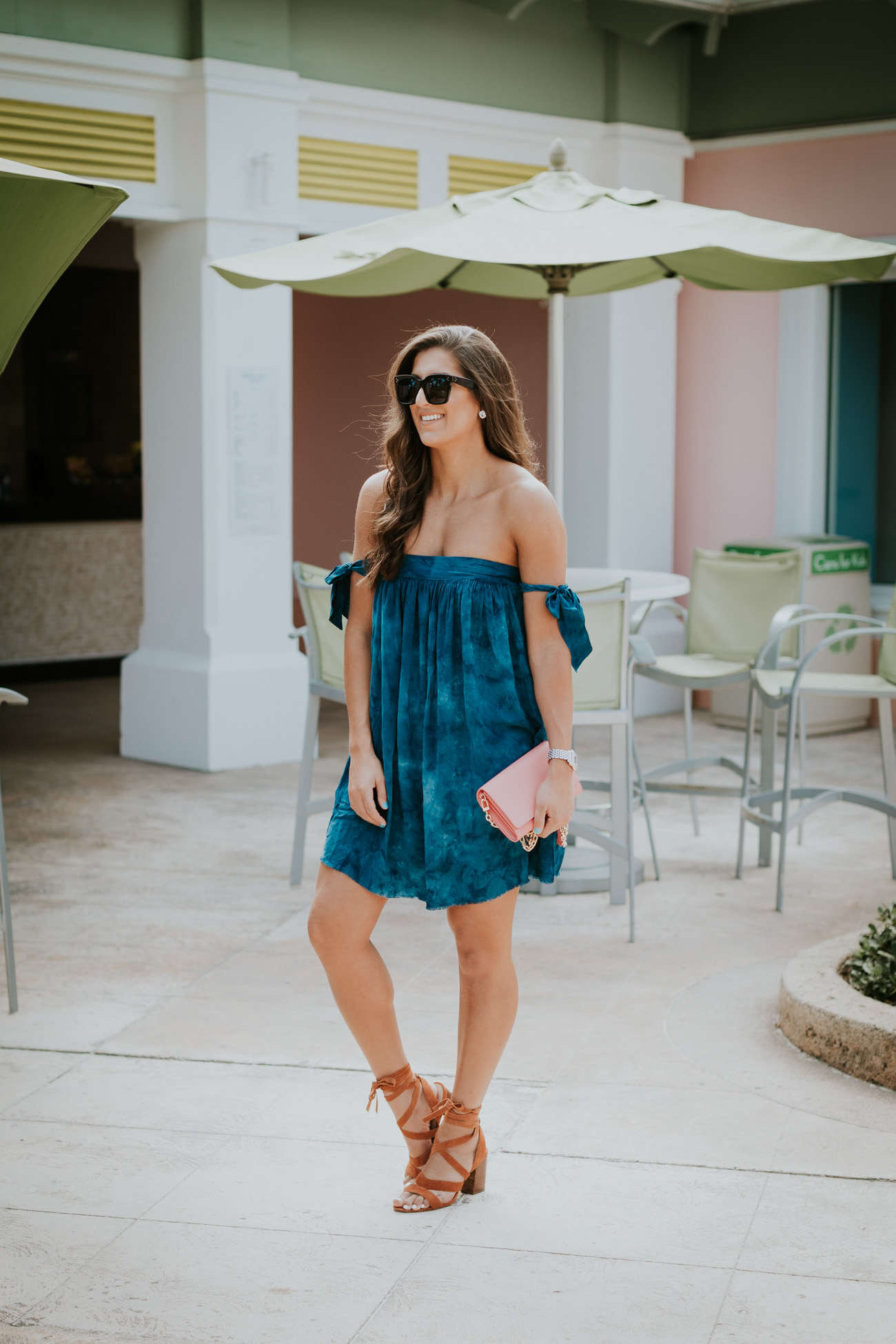off the shoulder bow dress, blue life off the shoulder dress,  blue life clothes, vacation outfit, vacation style, wraparound sandals, lace up sandals, celine sunglasses, pink tory burch bag, pink tory burch crossbody bag, tory burch chain wallet, bahamas outfit, beachside, beachy outfit // grace wainwright a southern drawl
