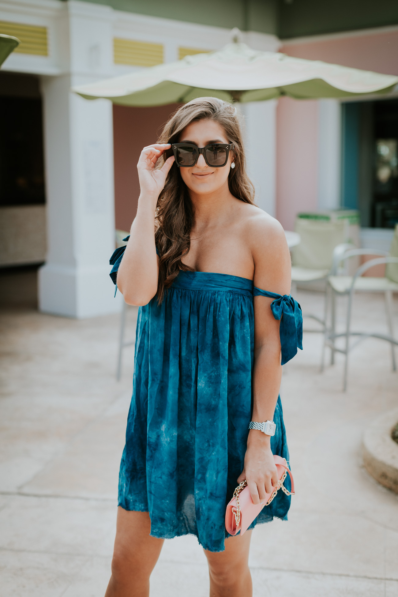 off the shoulder bow dress, blue life off the shoulder dress,  blue life clothes, vacation outfit, vacation style, wraparound sandals, lace up sandals, celine sunglasses, pink tory burch bag, pink tory burch crossbody bag, tory burch chain wallet, bahamas outfit, beachside, beachy outfit // grace wainwright a southern drawl