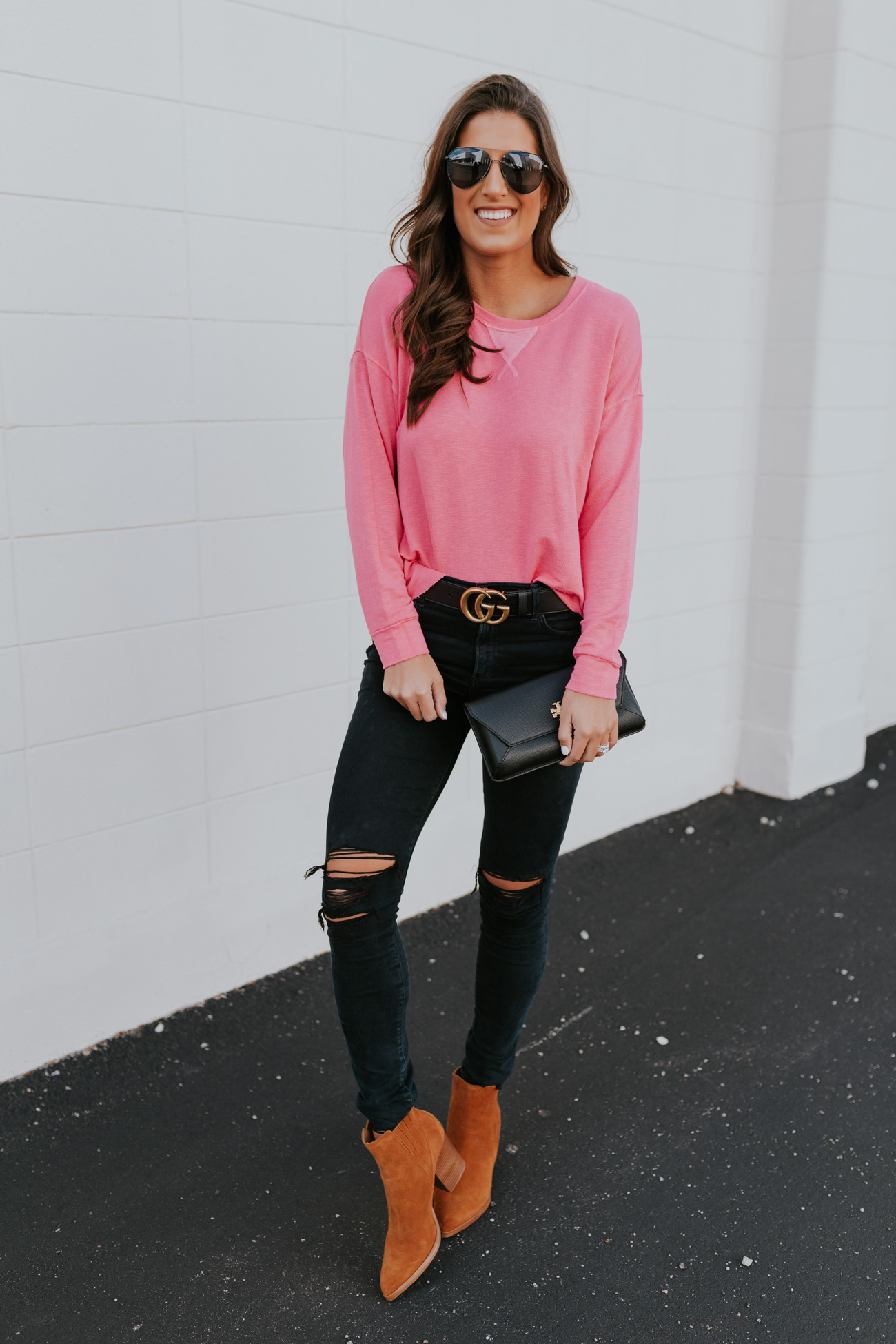 neon pink sweatshirt, cozy style, black distressed jeans, casual fashion, casual outfit, gucci belt, black gucci belt, tory burch kira envelope clutch // grace white a southern drawl